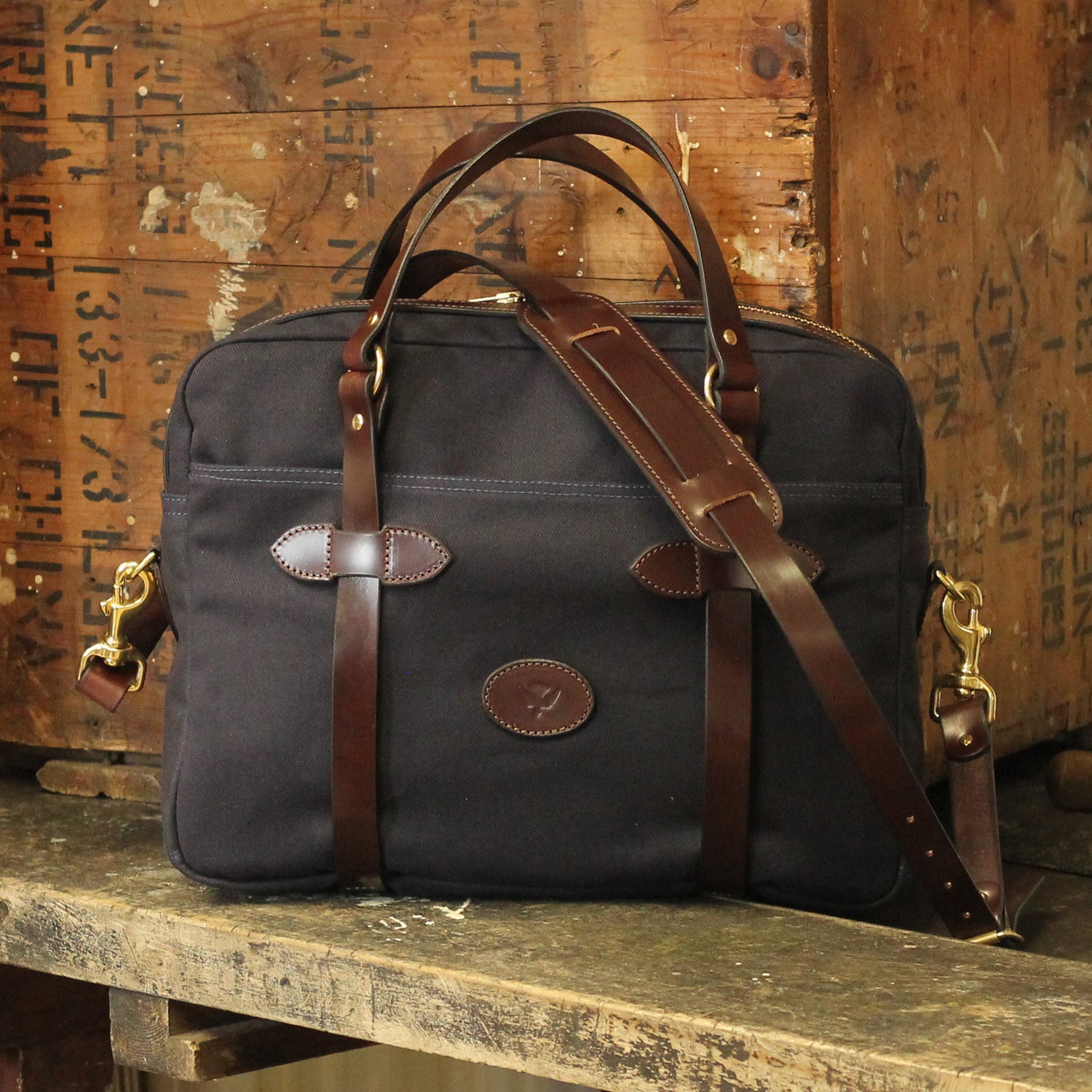 a canvas briefcase and laptop bag with leather accents by ashley clarke