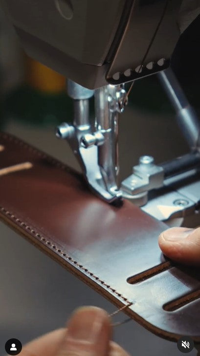 Stitching a shoulder pad for one of our briefcases...