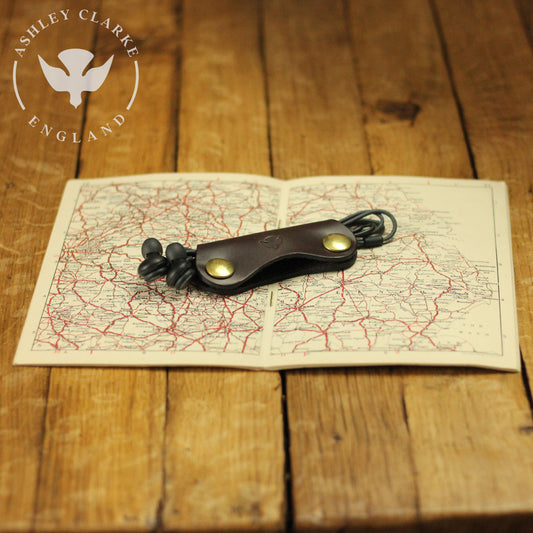 bridle leather cable tidies by Ashley Clarke England on top of a map