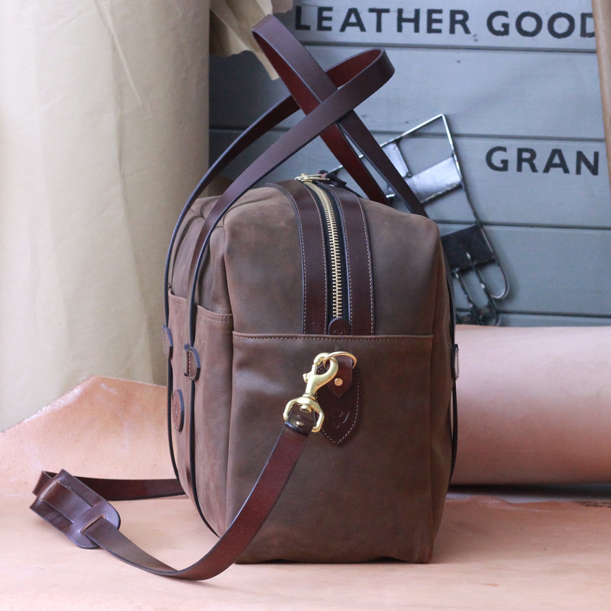 A leather luggage bag on a workbench in England