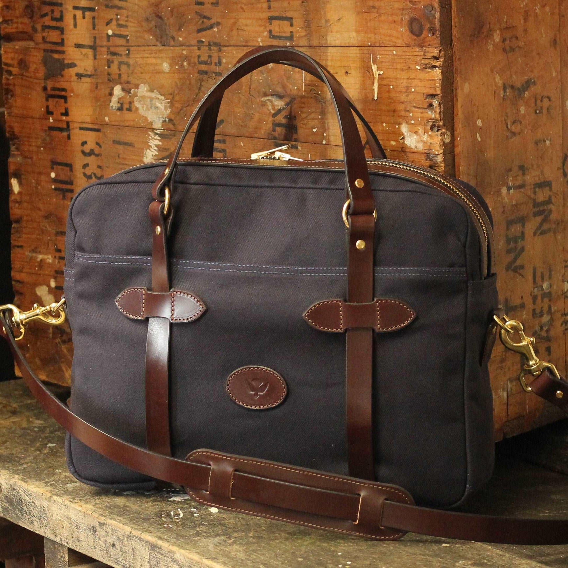 a canvas work bag and laptop bag briefcase with leather accents
