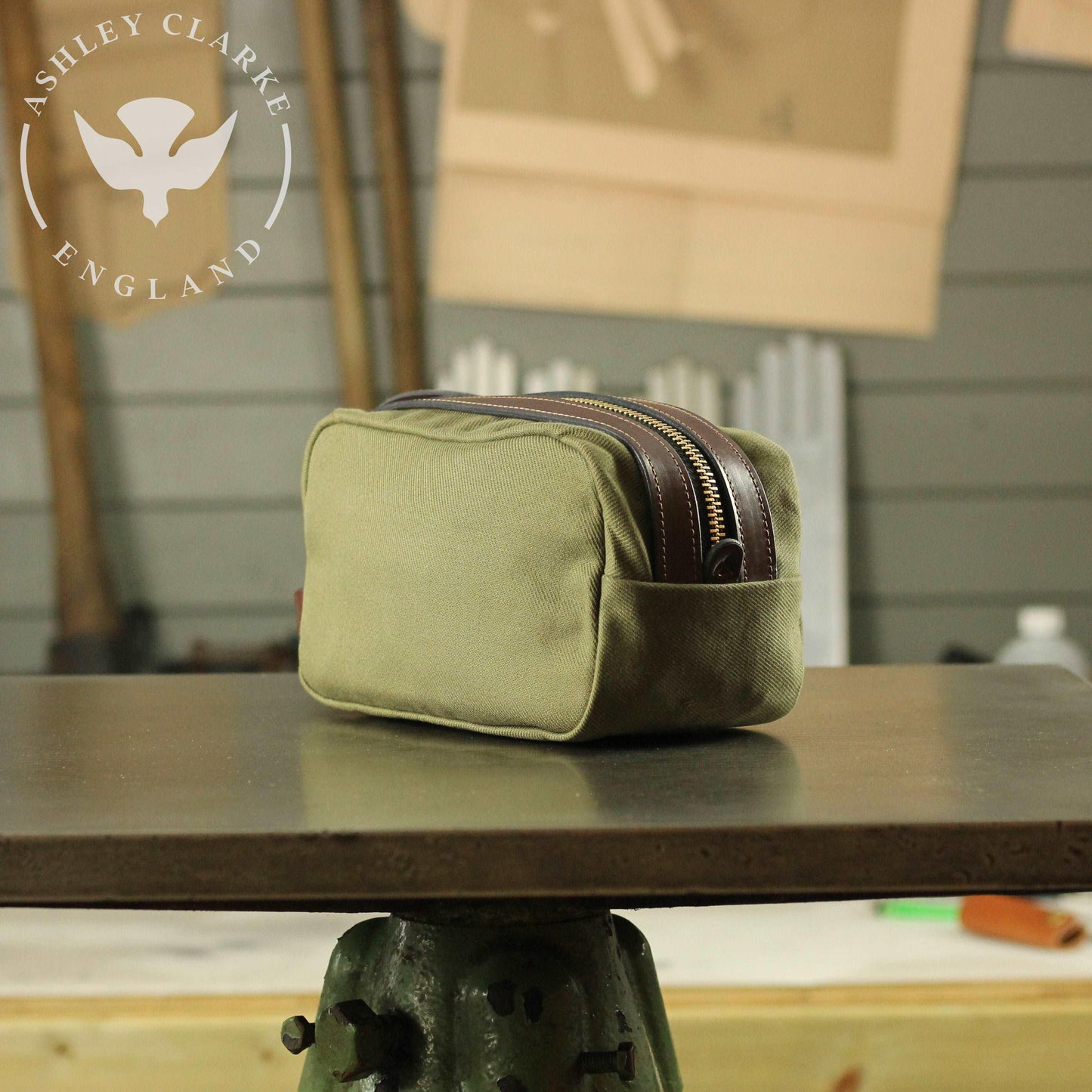 back view of a waxed canvas wash bag by ashley clarke england on top of a table workshop 