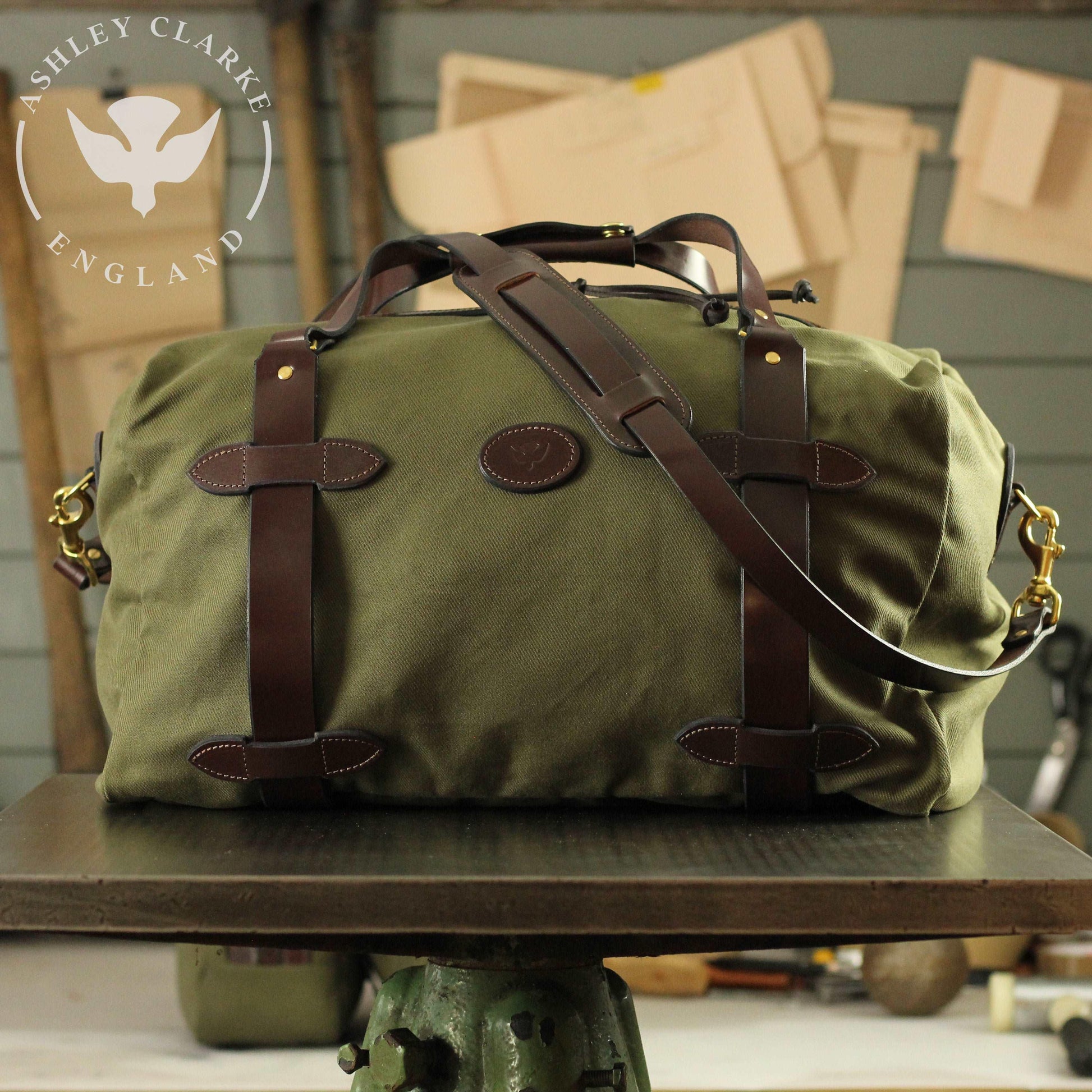a green waxed canvas holdall bag by ashley clarke england on top of a table 2
