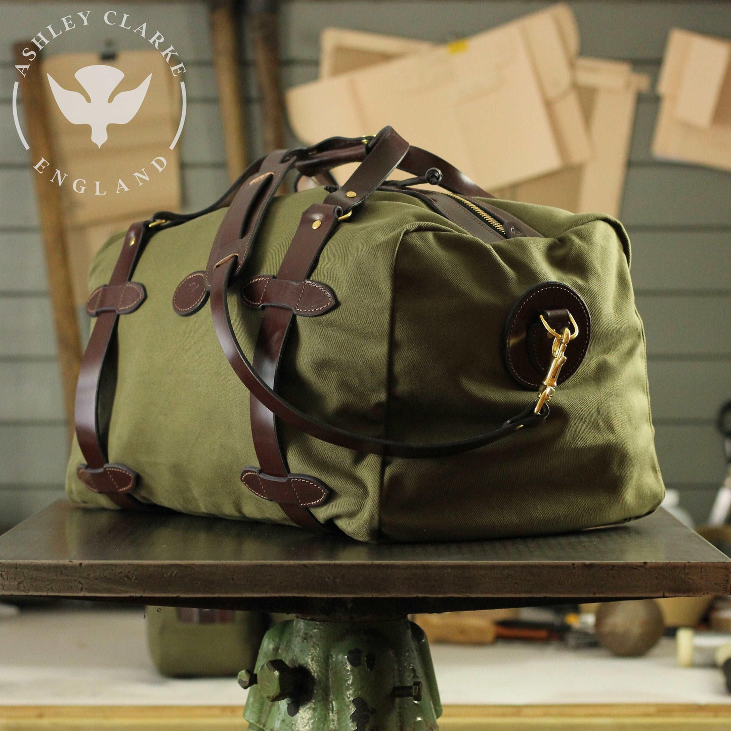 a green waxed canvas holdall bag by ashley clarke england on top of a table 3