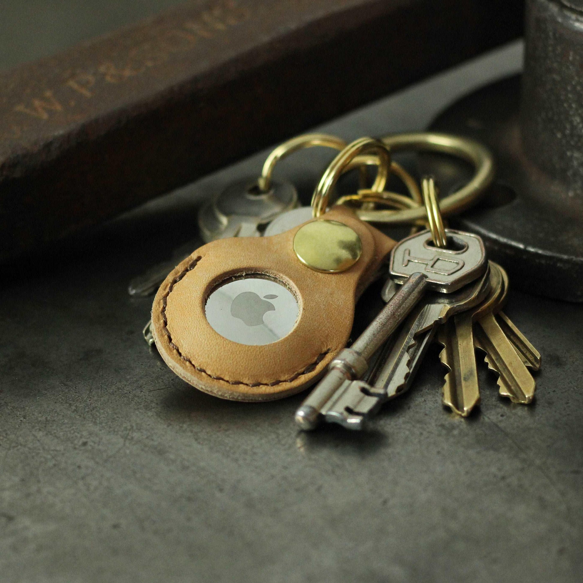 ashley clarke's leather apple airtag case key fob with keys attached