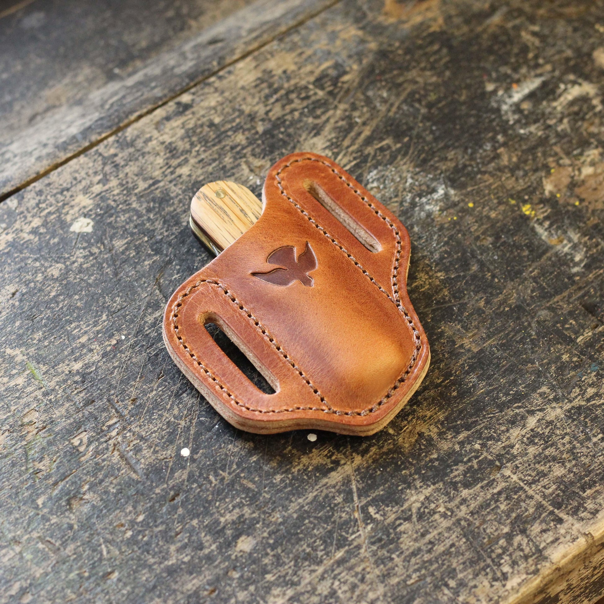 a pocket knife inside a leather holster by ashley clarke