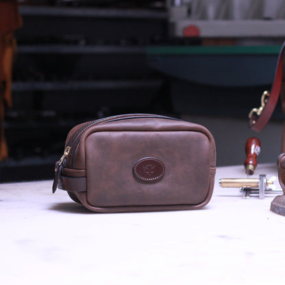 Brown leather washbag on a workbench