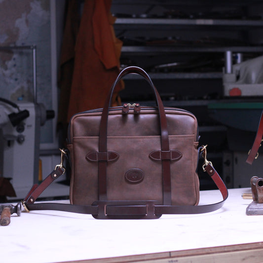 Brown leather briefcase on a workbench